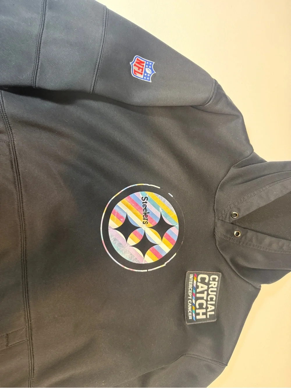 Crucial Catch Black Pullover with Multicolor Stripe Patch